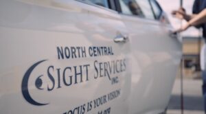 north central sight services vehicle. It is white with a blue logo. 